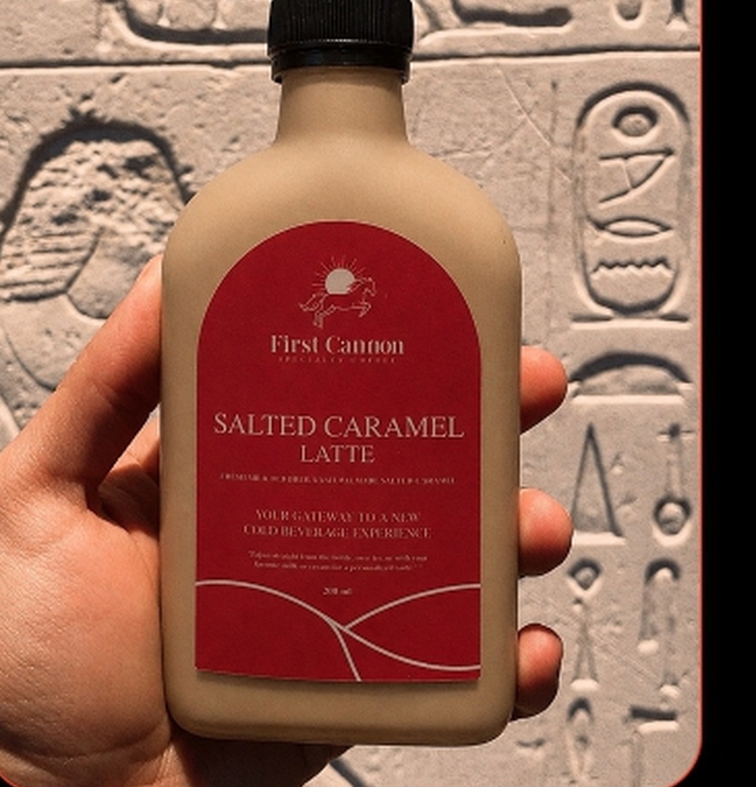 First Cannon Salted Caramel Latte Bottle in Front of Hieroglyph Wall
